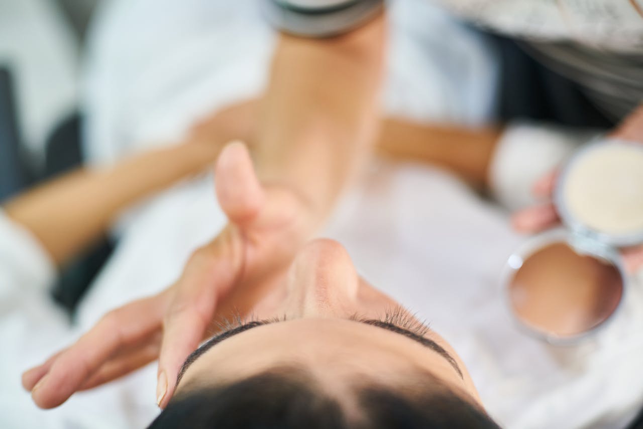 Home Close-up view of a professional makeup artist applying cosmetics indoors, highlighting beauty and skin care.