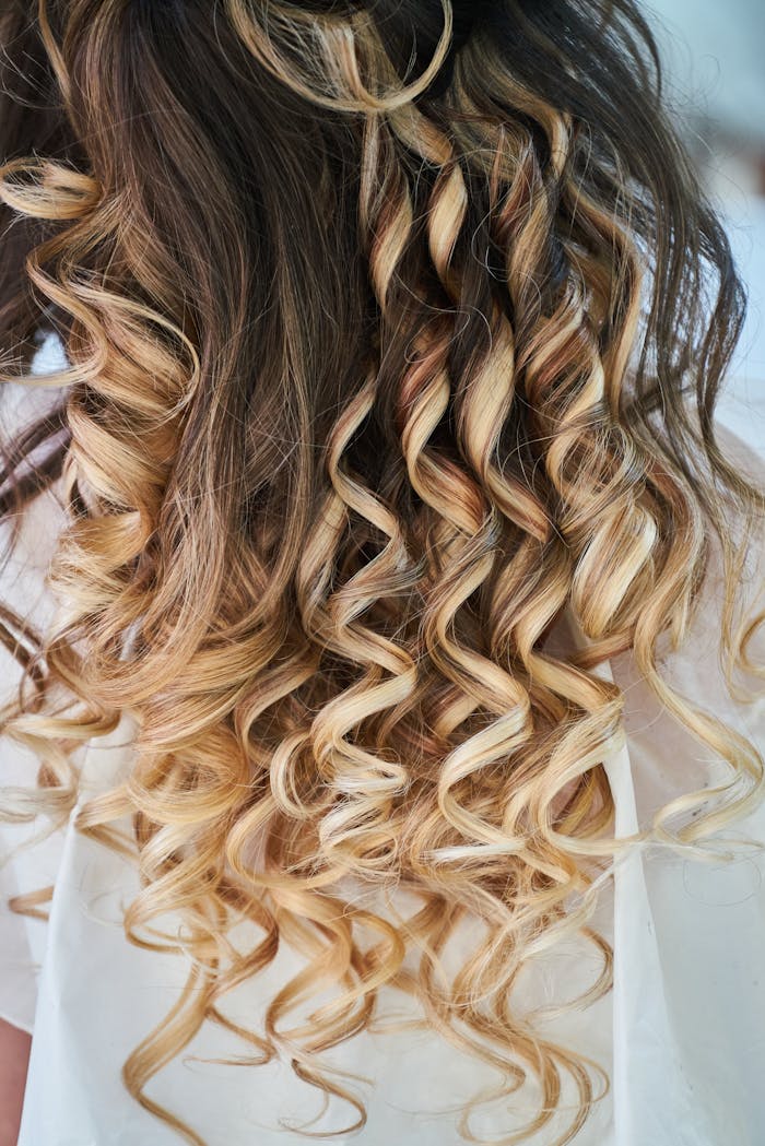 Home Close-up of elegant blonde curls showcasing detailed hairstyle design.